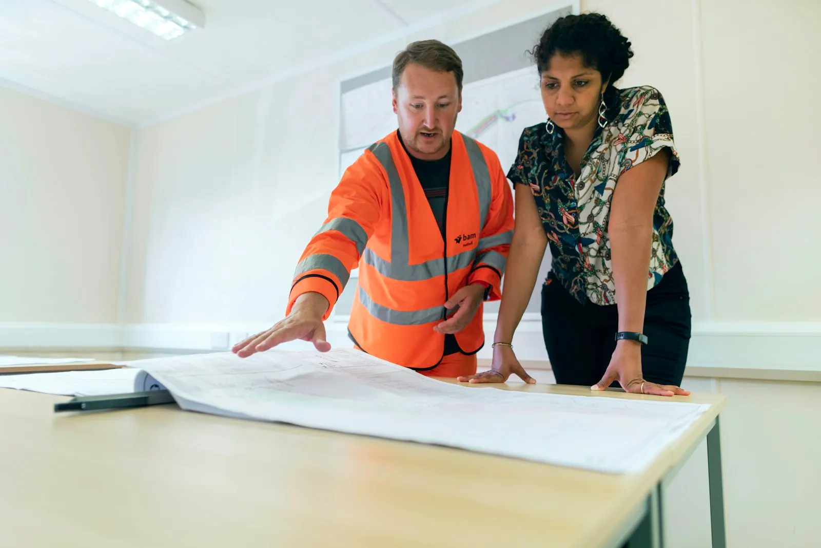 Engineers reviewing issued-for-construction drawings at a plan table