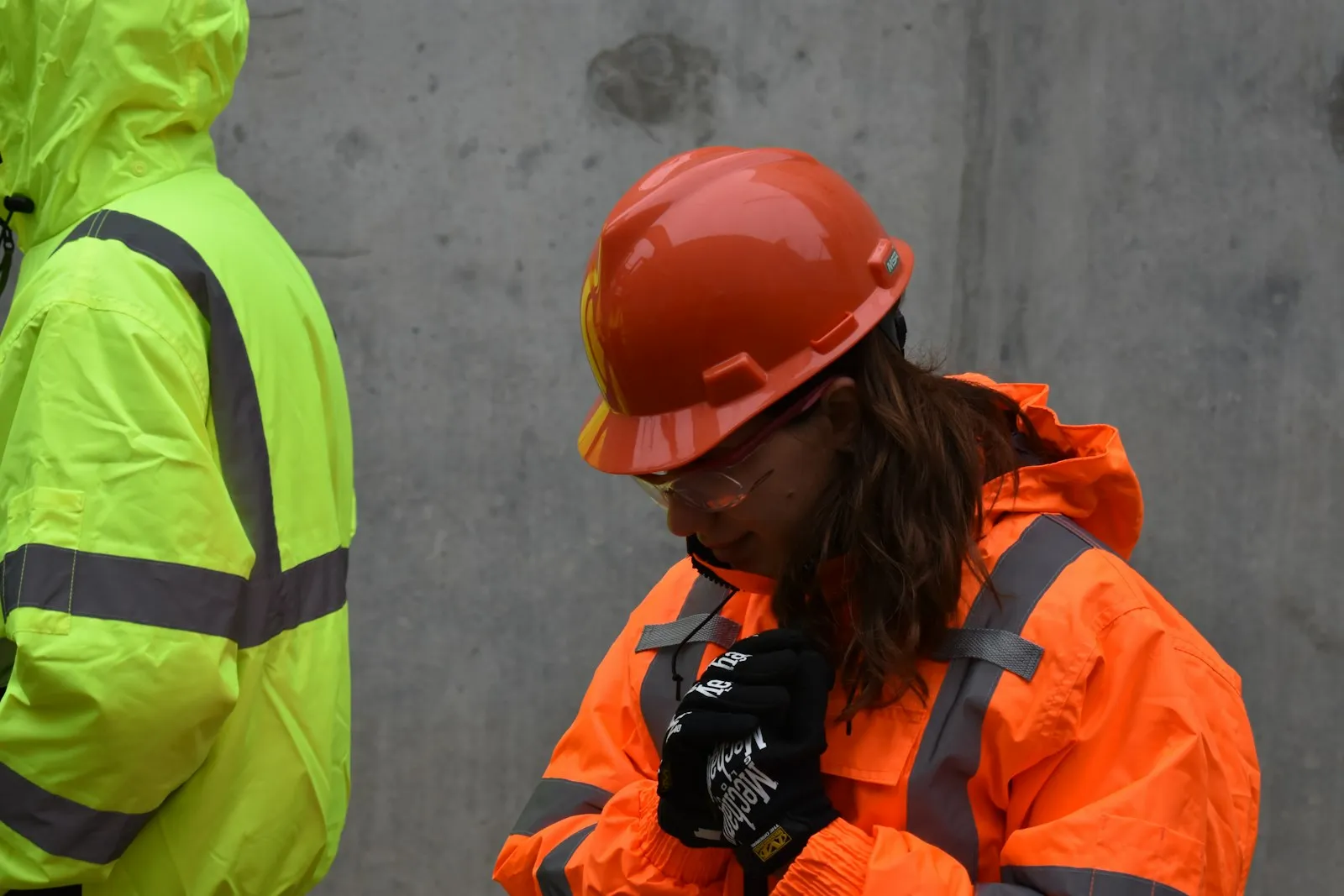 Crew in hard hats and high-visibility clothing checking work on site